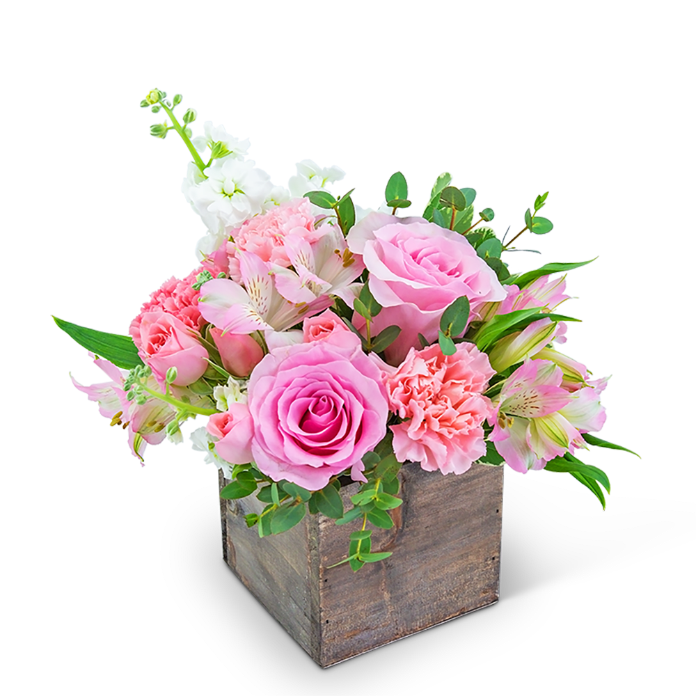 Pink and white floral arrangement in a rustic wooden box