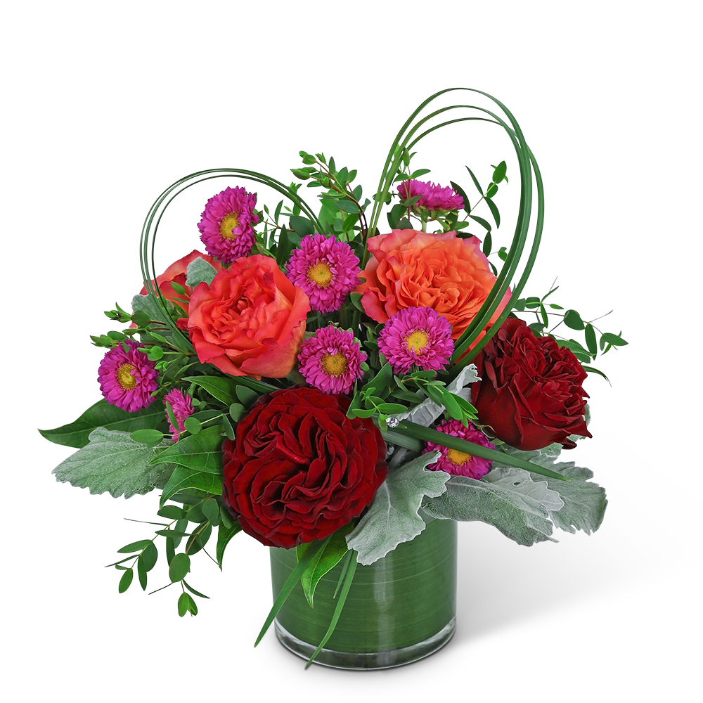 Bouquet of red and orange roses with purple daisies in a glass vase