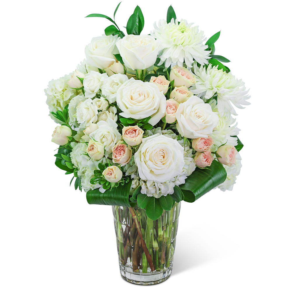 White roses and chrysanthemums in a clear glass vase