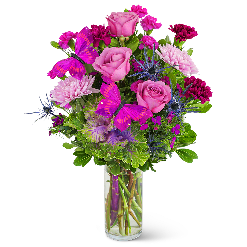 Pink roses and magenta flowers in a clear glass vase with purple butterflies