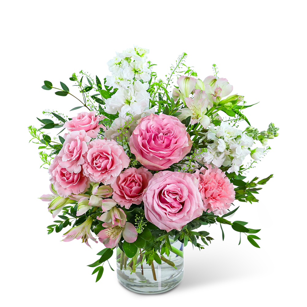 Pink roses and white flowers arranged in a clear glass vase