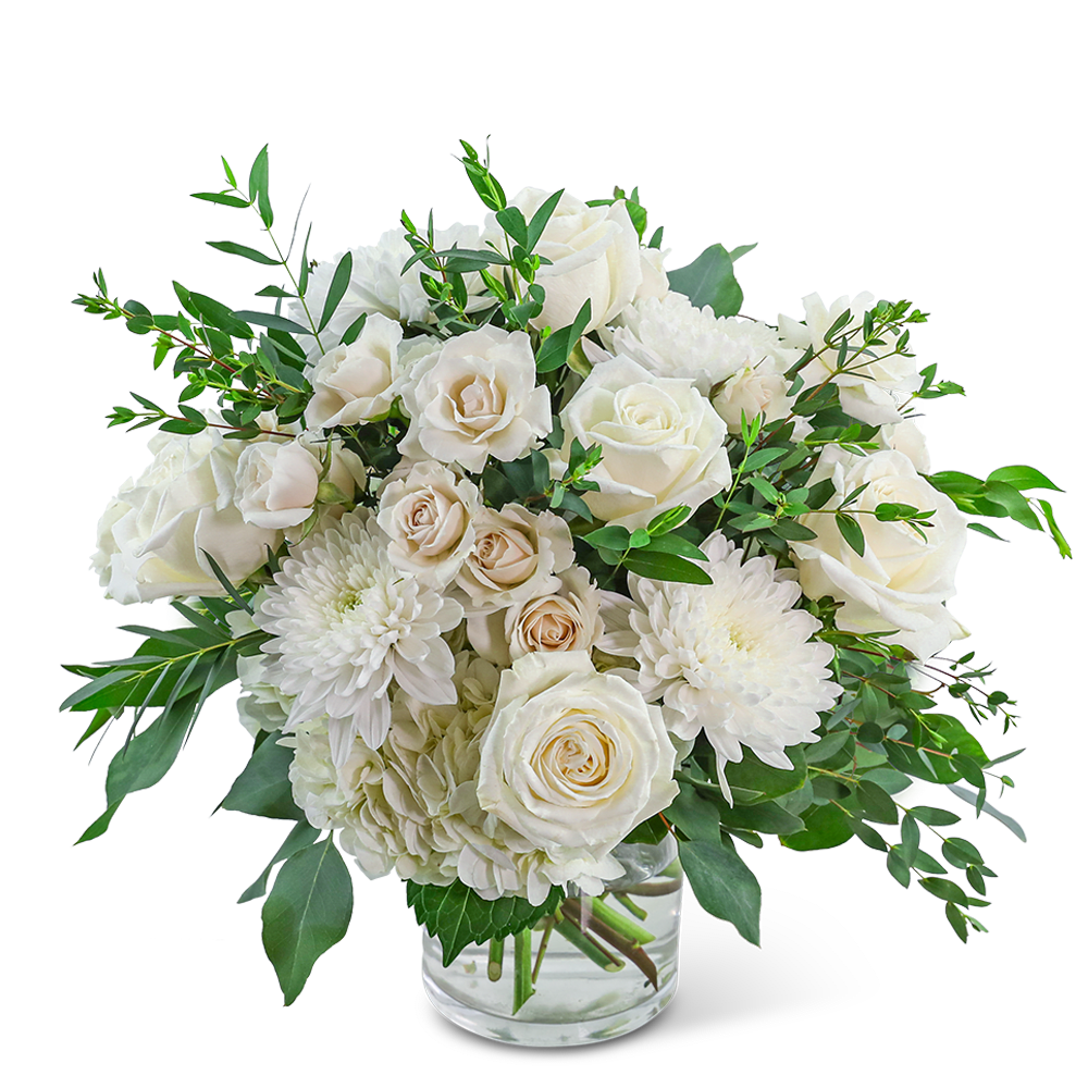 White roses and chrysanthemums in a clear glass vase