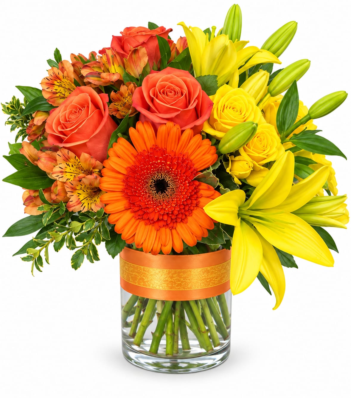 Bright mixed bouquet of roses, lilies, and gerbera daisies in a glass vase