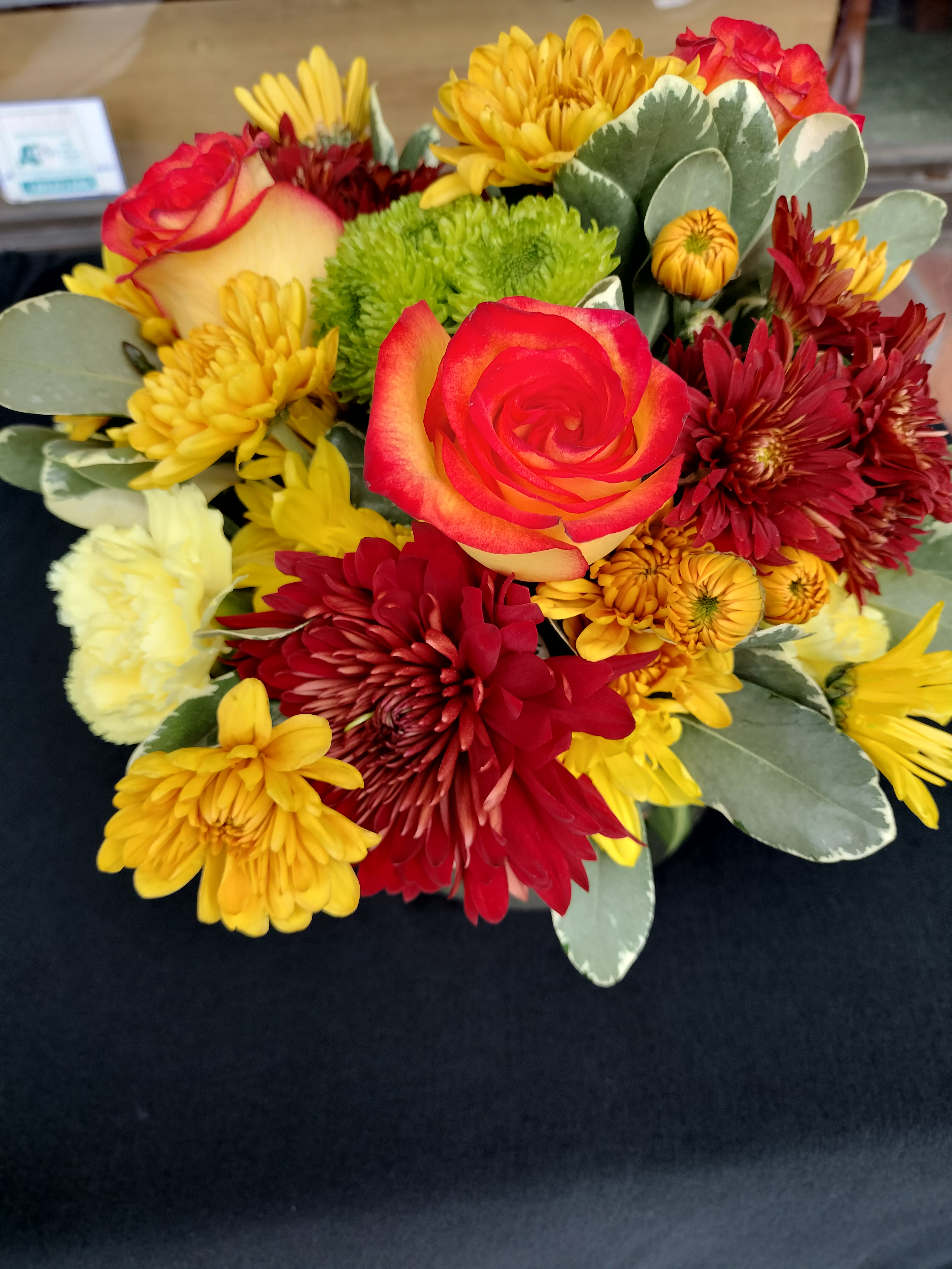 Mixed bouquet with red and yellow roses and chrysanthemums
