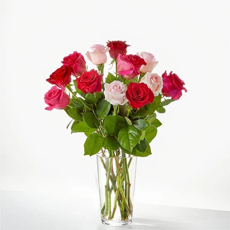 Bouquet of red and pink roses in a clear glass vase