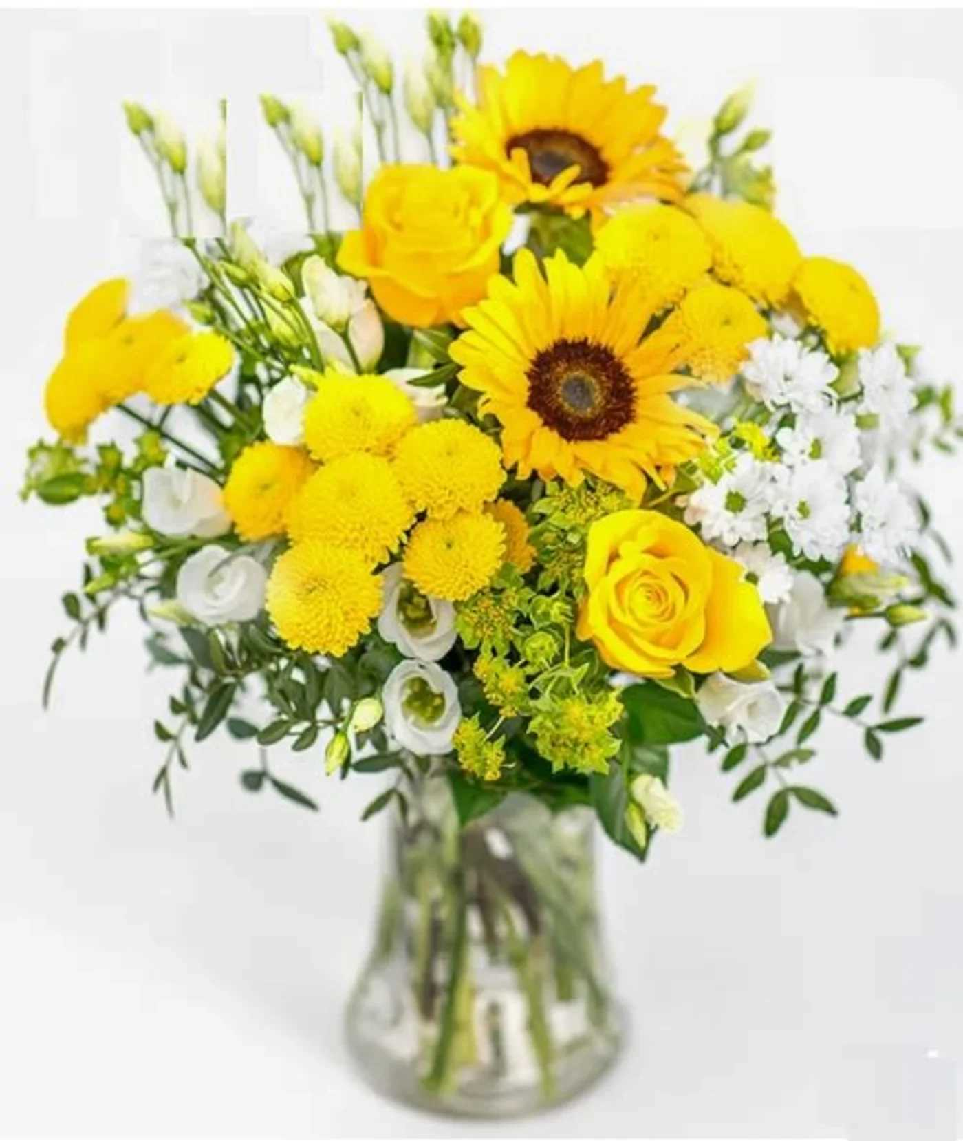 Yellow bouquet with roses, sunflowers, and white blooms in a glass vase