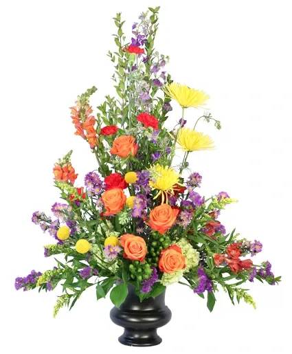 Tall mixed flower arrangement in a black urn vase