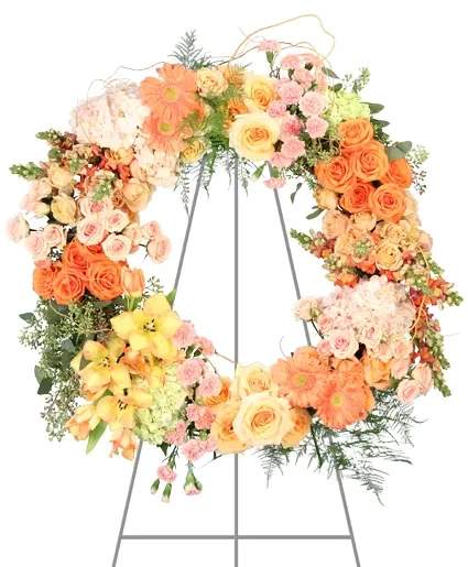 Large pastel floral wreath on a metal stand