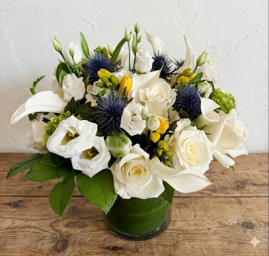 Whimsy  - The arrangement stays in a light color tone. It's a great choice for an elegant lady or for "him".