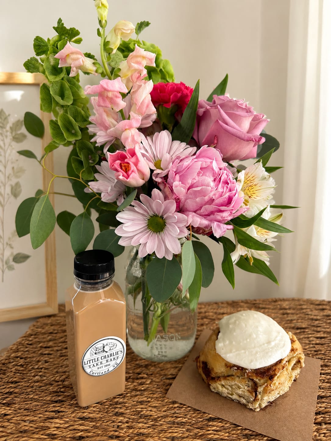 A Sweet Treat - Celebrate your special someone with the sweetest little moment - a freshly designed blooming bouquet in a keepsake jar, paired with a jumbo sourdough cinnamon roll and a Cookie Butter bottled latte from Little Charlie's Bake Shop. Must be ordered a day in advance.