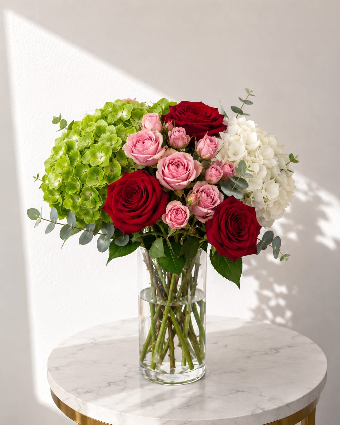 Blush Garden - A beautiful and elegant vase arrangement featuring premium seasonal blooms in soft blush, classic red, and fresh white tones. Designed with lush textures and a modern garden-inspired style, this arrangement creates a timeless and sophisticated look for any occasion.  Perfect for birthdays, anniversaries, thank you gifts, celebrations, or simply brightening someone’s day. Handcrafted with fresh flowers and arranged in a clear glass vase for a stunning presentation that is ready to enjoy upon arrival.  Flowers may vary slightly based on seasonal availability while maintaining the overall style, color palette, and value of the arrangement.
