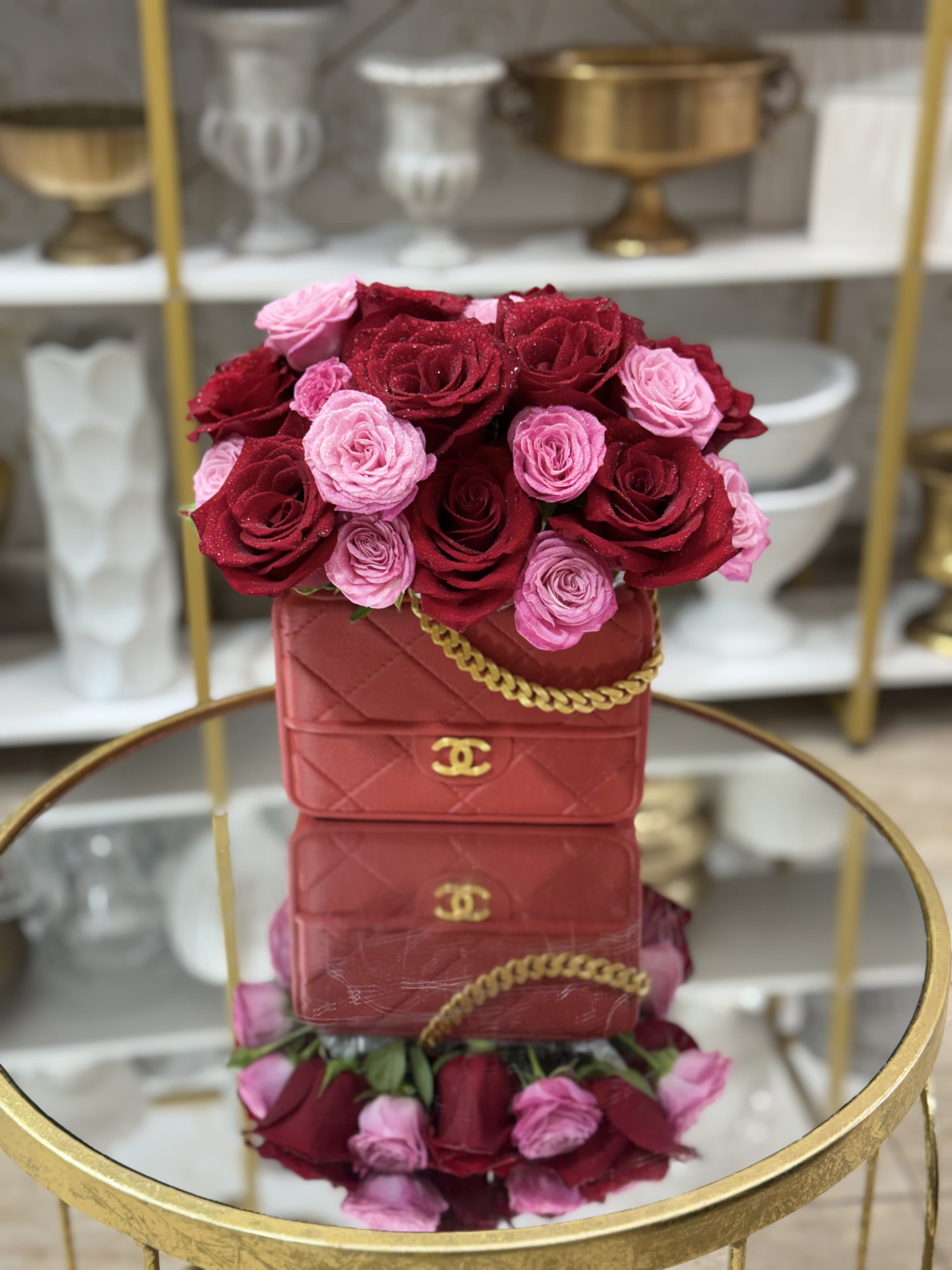 Red and pink roses arranged in a red handbag-shaped box