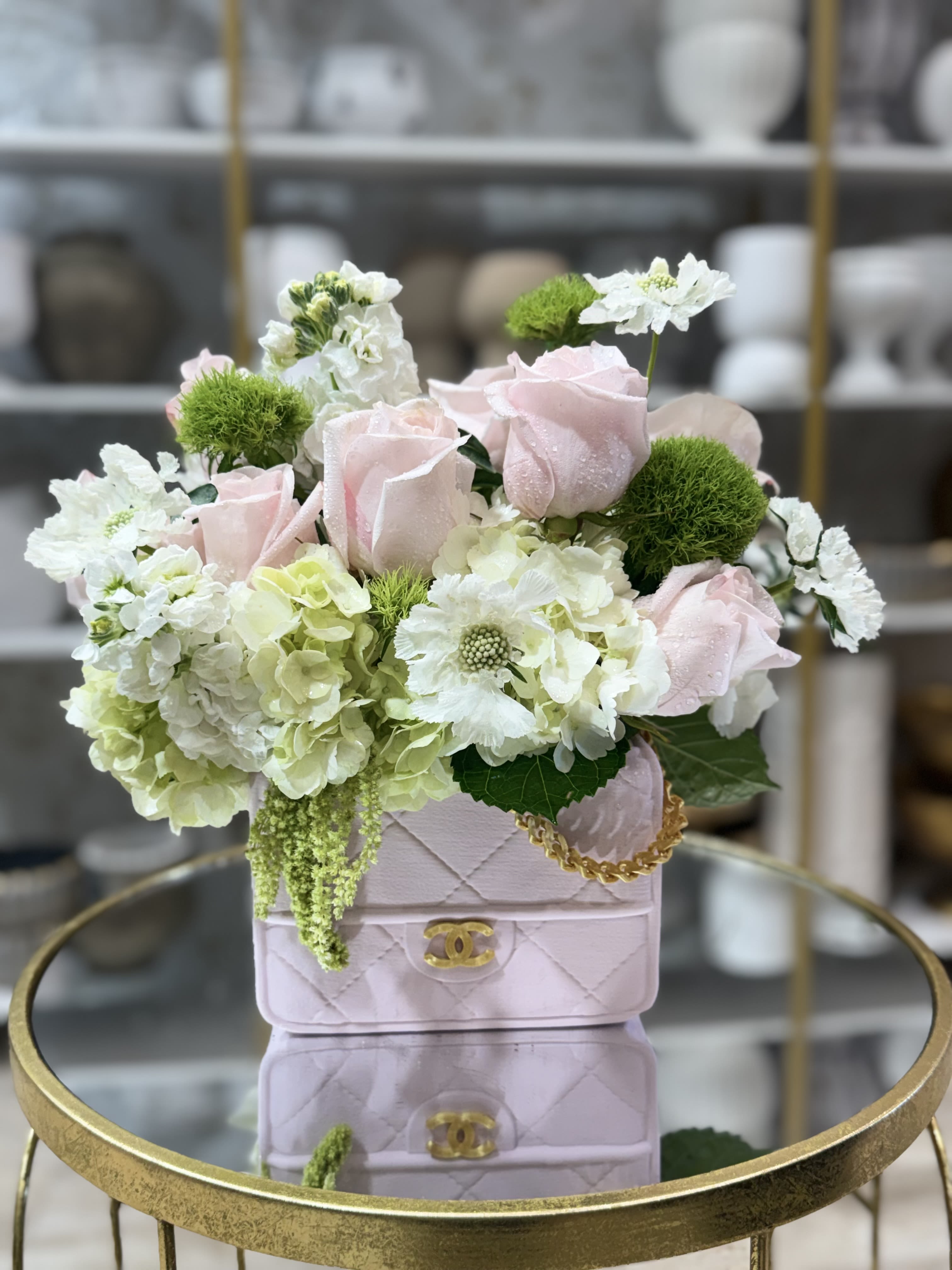 Chanel  - Gorgeous arrangement  of roses, orchids and more in a Channel purveyor vase 