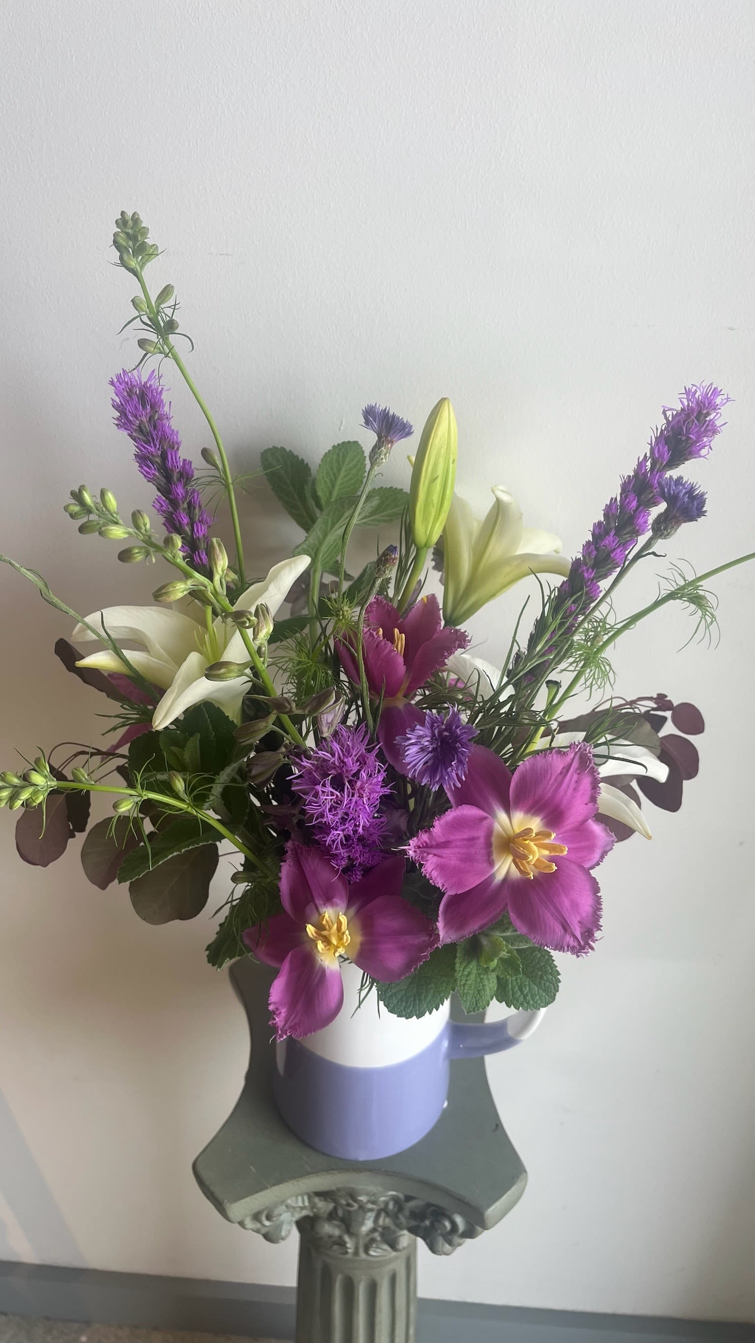 The Martha -- Pitcher with Blooms - Make Mother’s Day unforgettable with The Martha—a stunning, hand-arranged seasonal bouquet designed to delight. Choose from soft pinks or vibrant pastel florals, all thoughtfully styled in a ceramic pitcher that doubles as a keepsake.