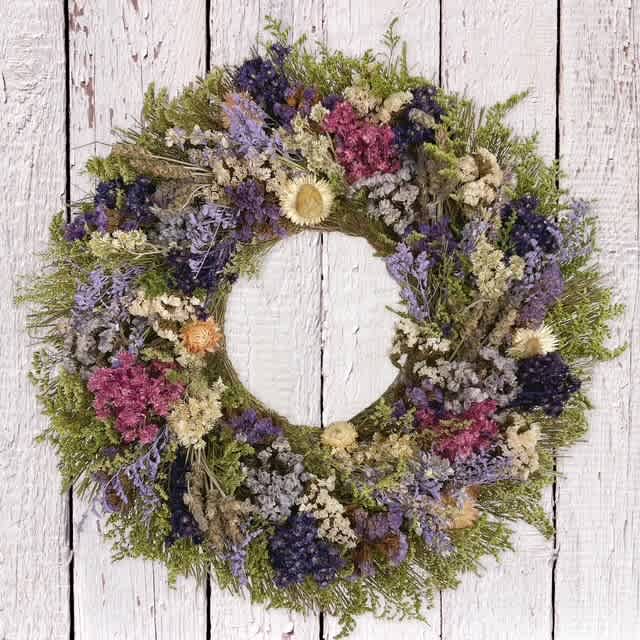 Round floral wreath with purple, pink, and cream dried flowers