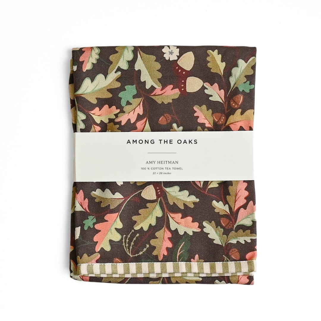 Folded tea towel with an oak leaf and acorn pattern
