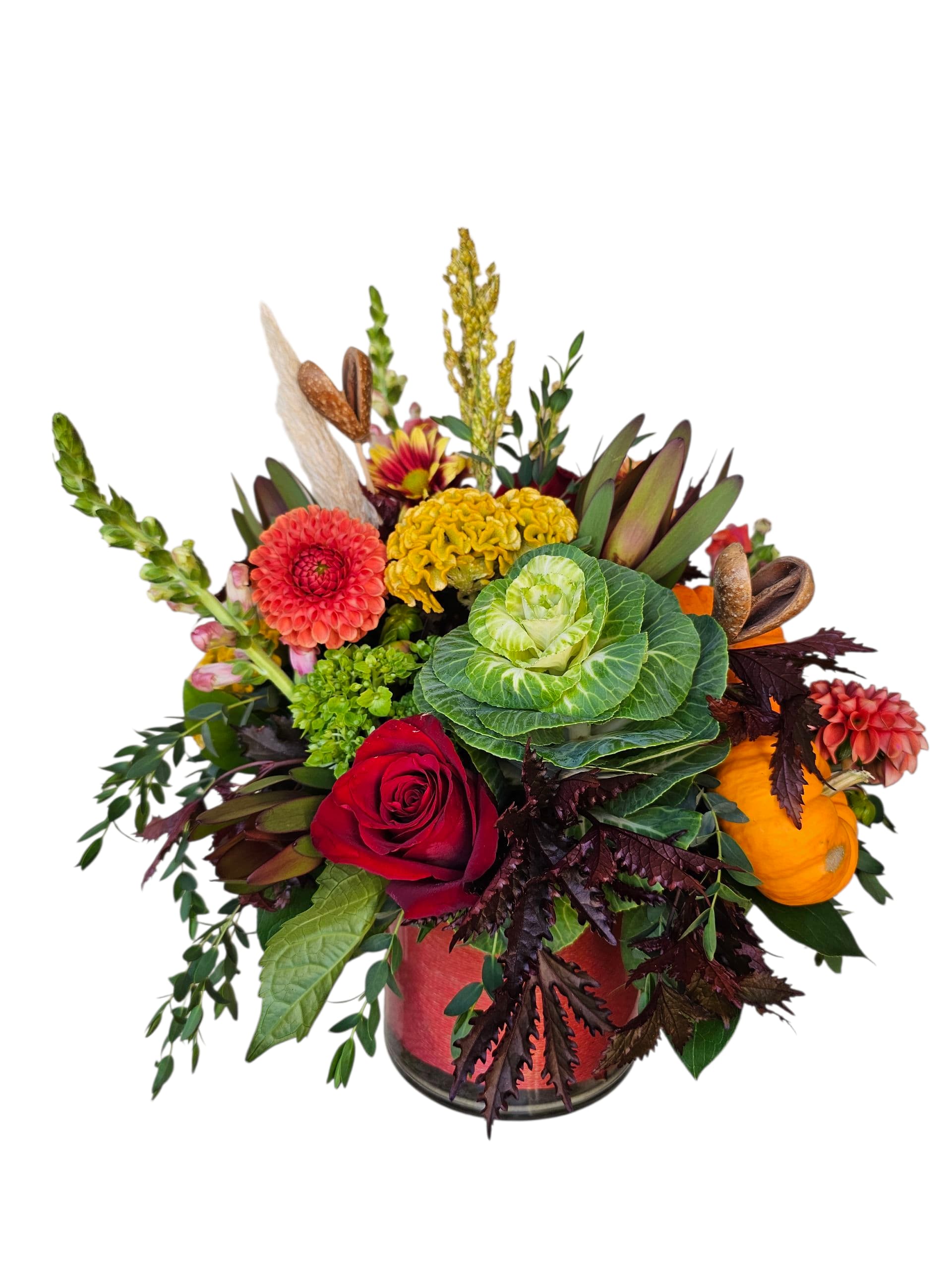 Mixed floral arrangement in a glass vase with a red rose and colorful blooms