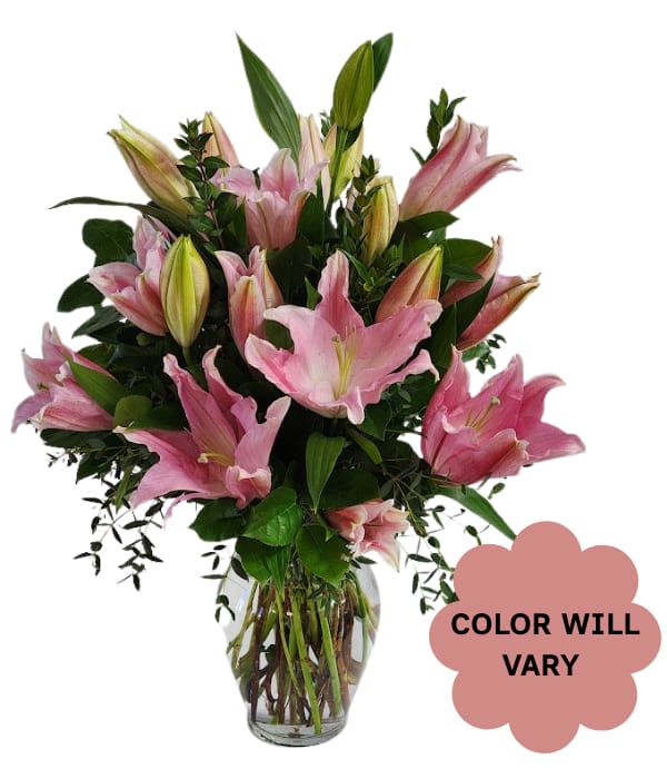 Pink lilies arranged in a clear glass vase