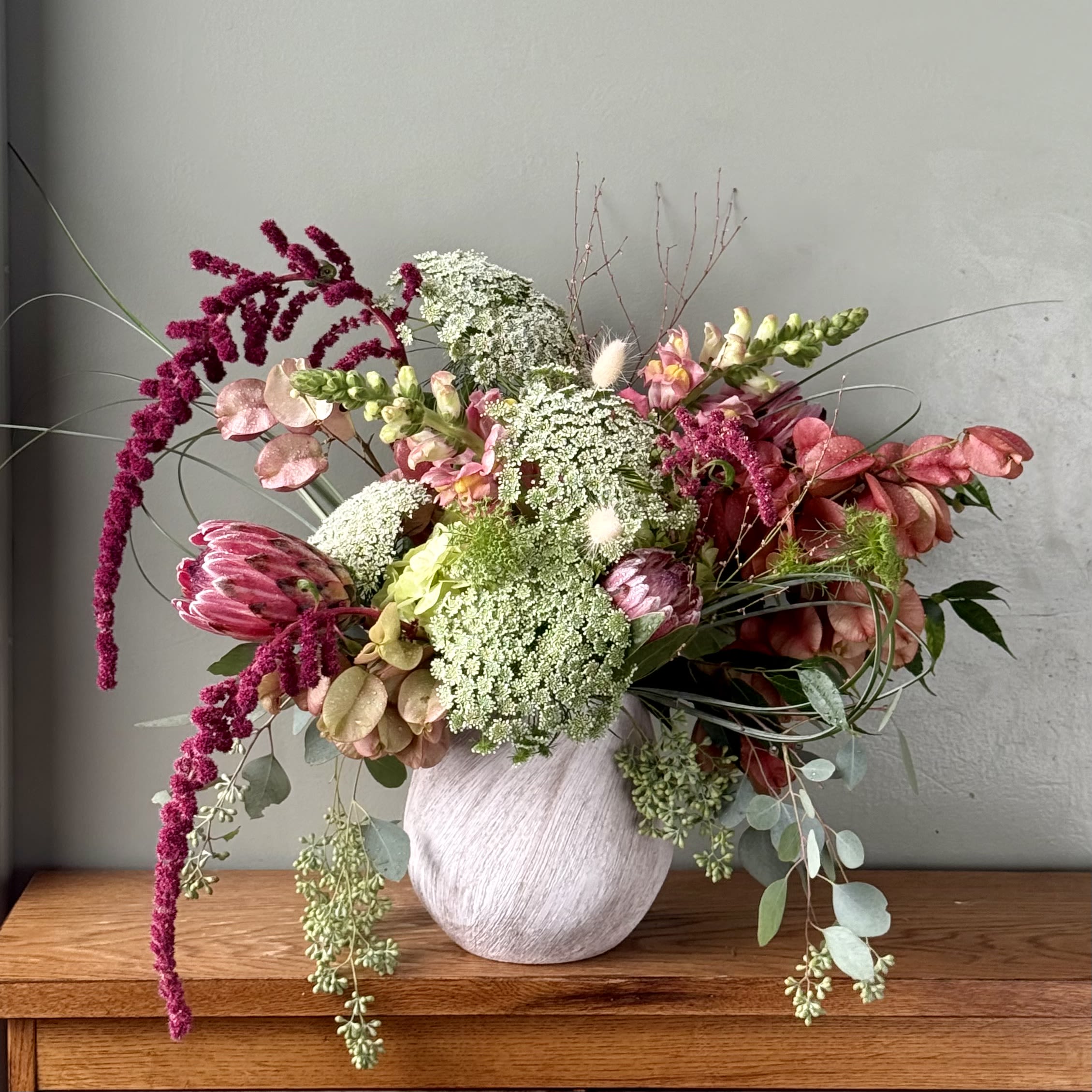 Mixed bouquet in a white vase with pink and white blooms