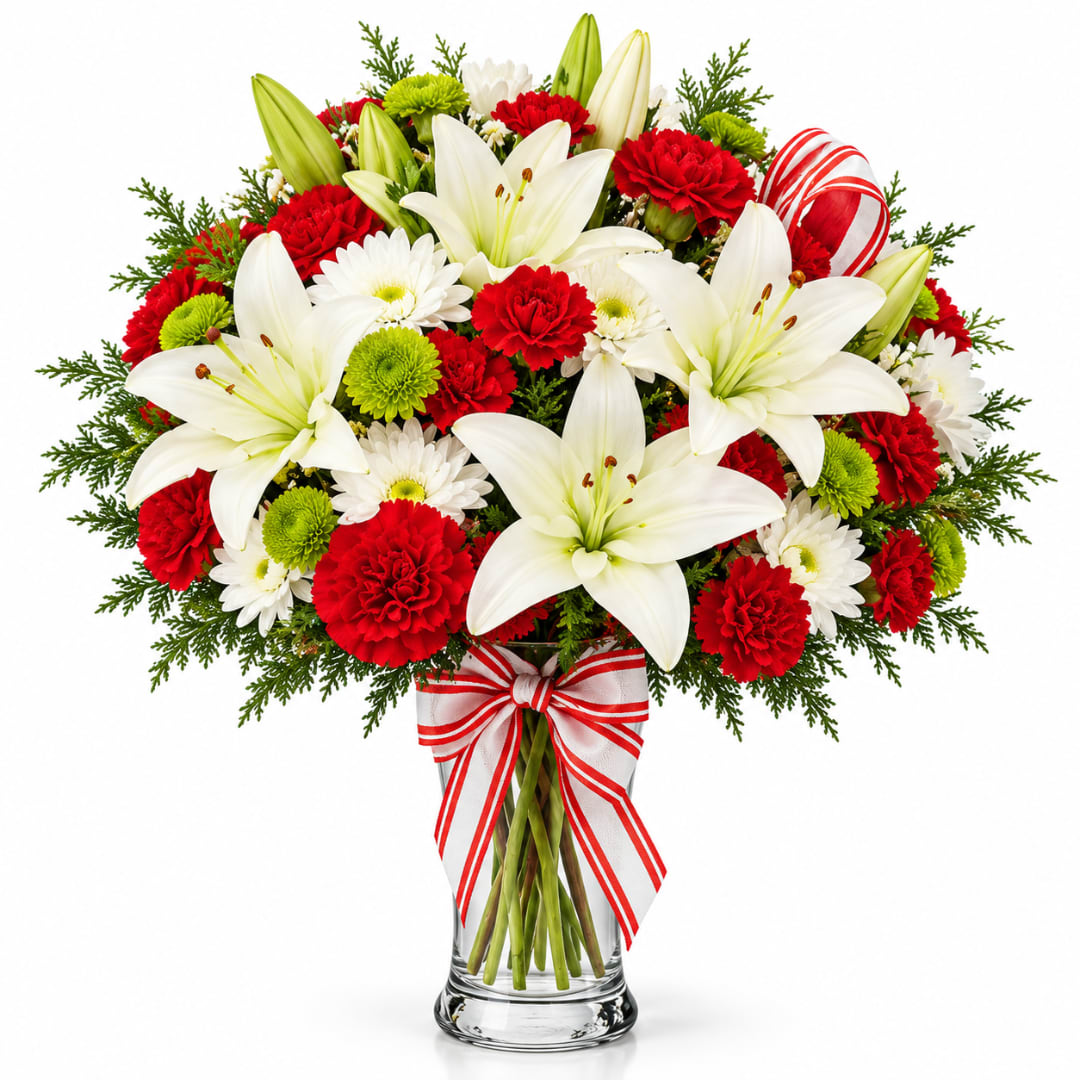 Red and white bouquet with lilies, carnations, and daisies in a glass vase