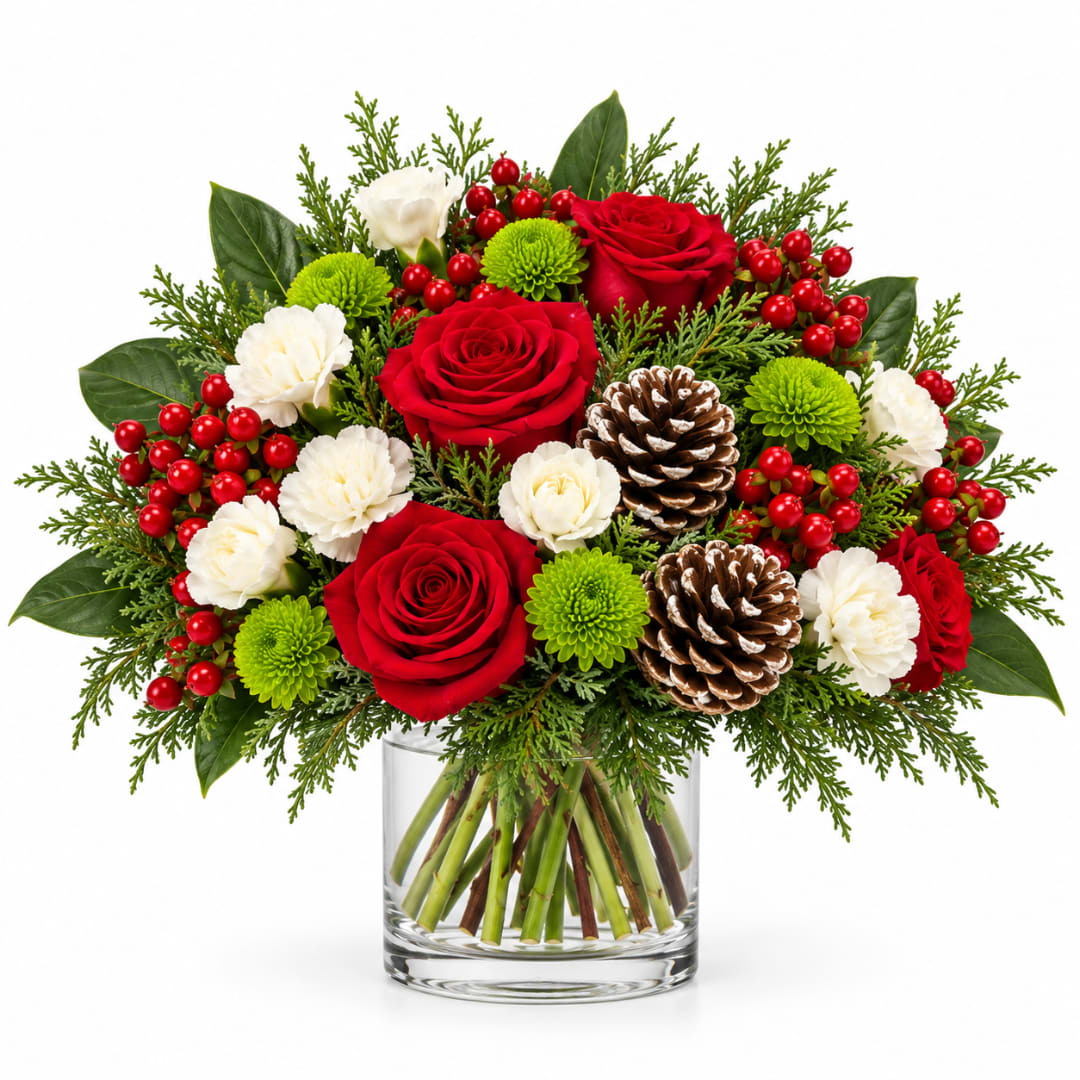 Red roses and white carnations in a glass vase with pinecones and berries