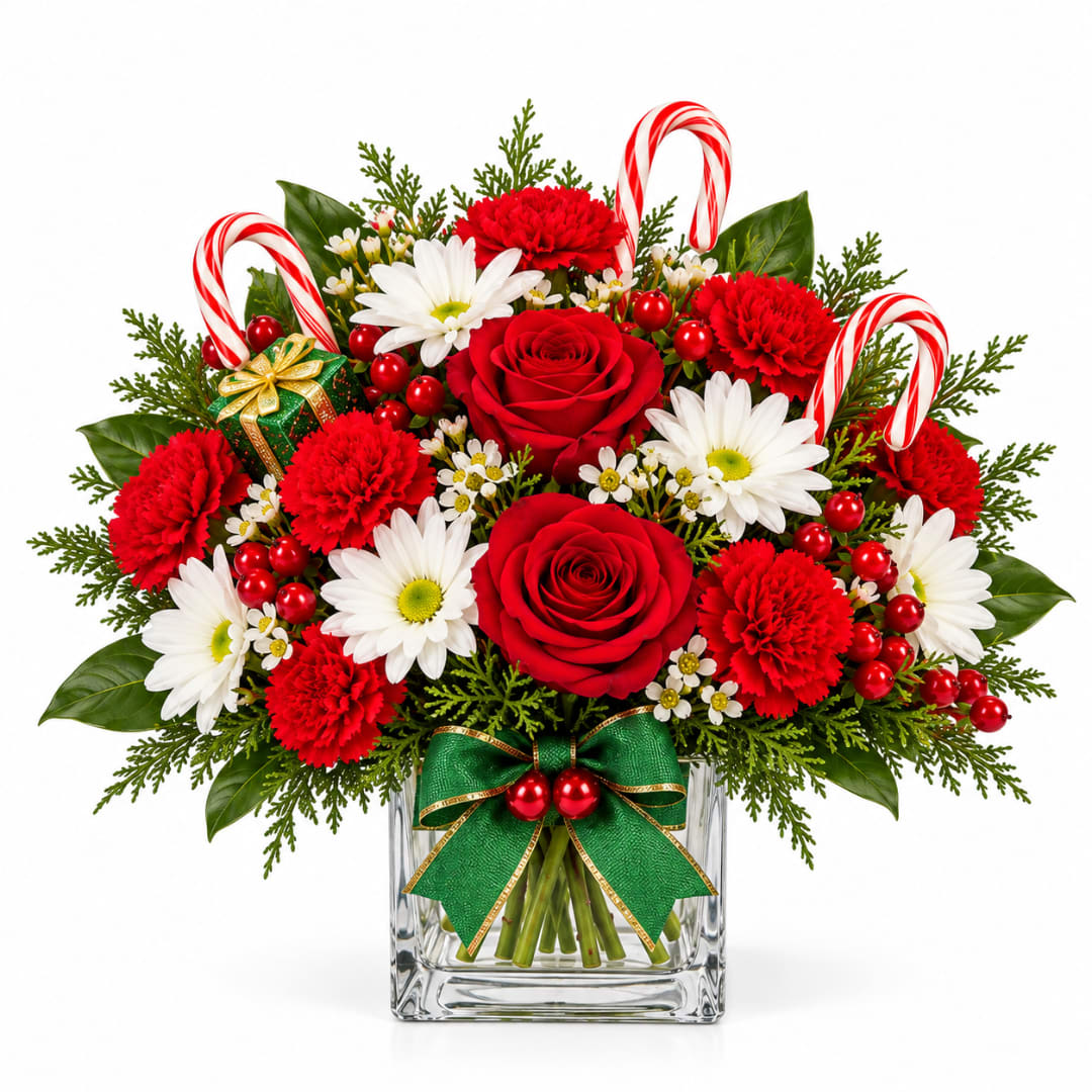 Christmas bouquet of red roses, white daisies, and red carnations in a glass vase
