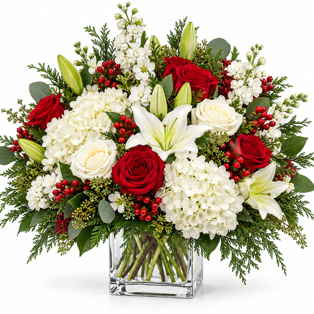 Red and white roses with lilies and hydrangeas in a glass vase