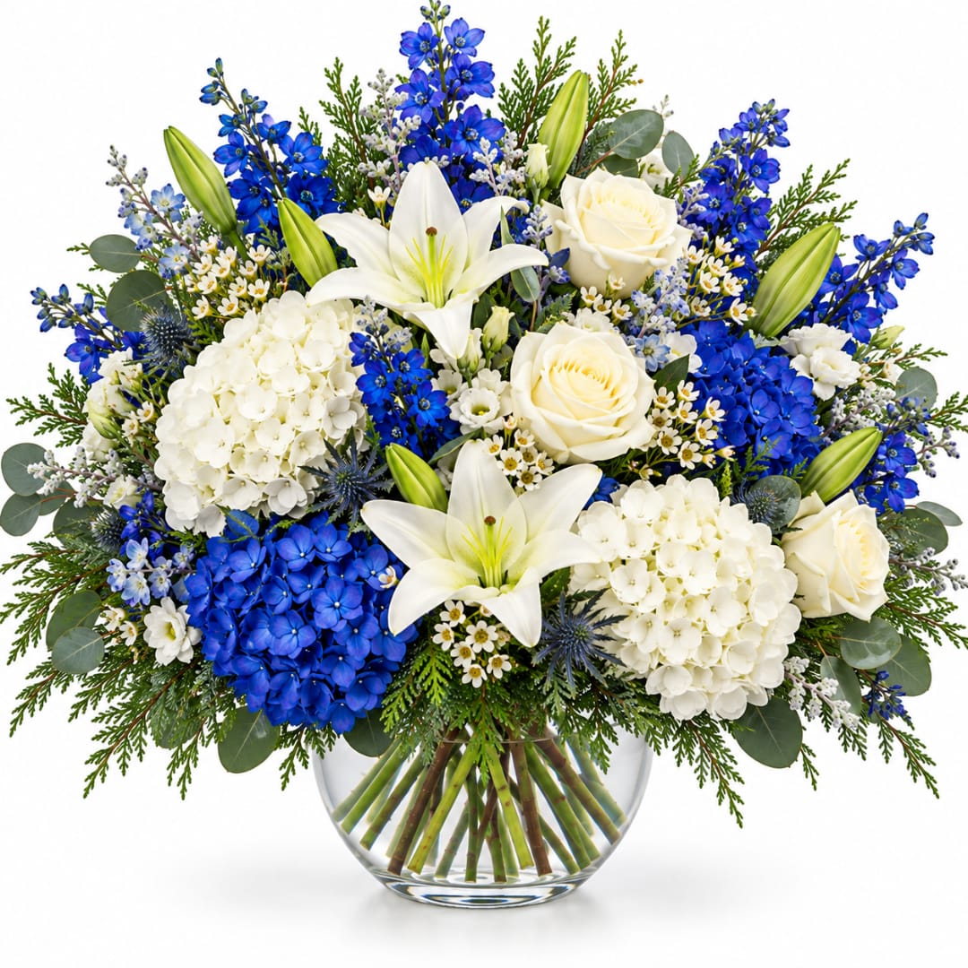Blue and white floral arrangement in a clear glass vase