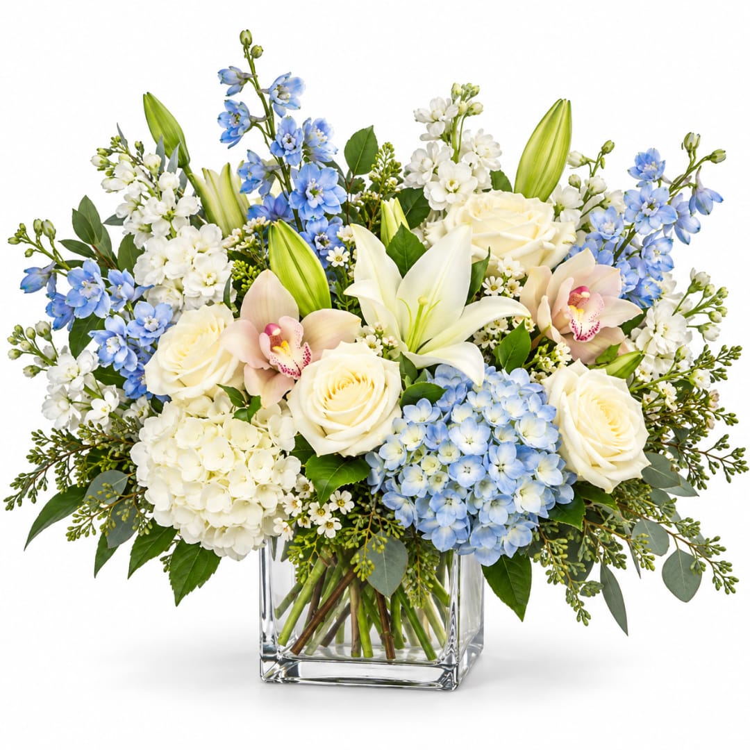 Blue and white floral arrangement in a clear glass vase