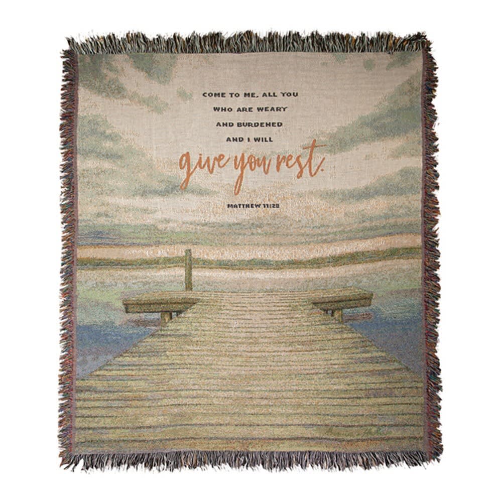 Fringed woven blanket with a dock scene and Bible verse text