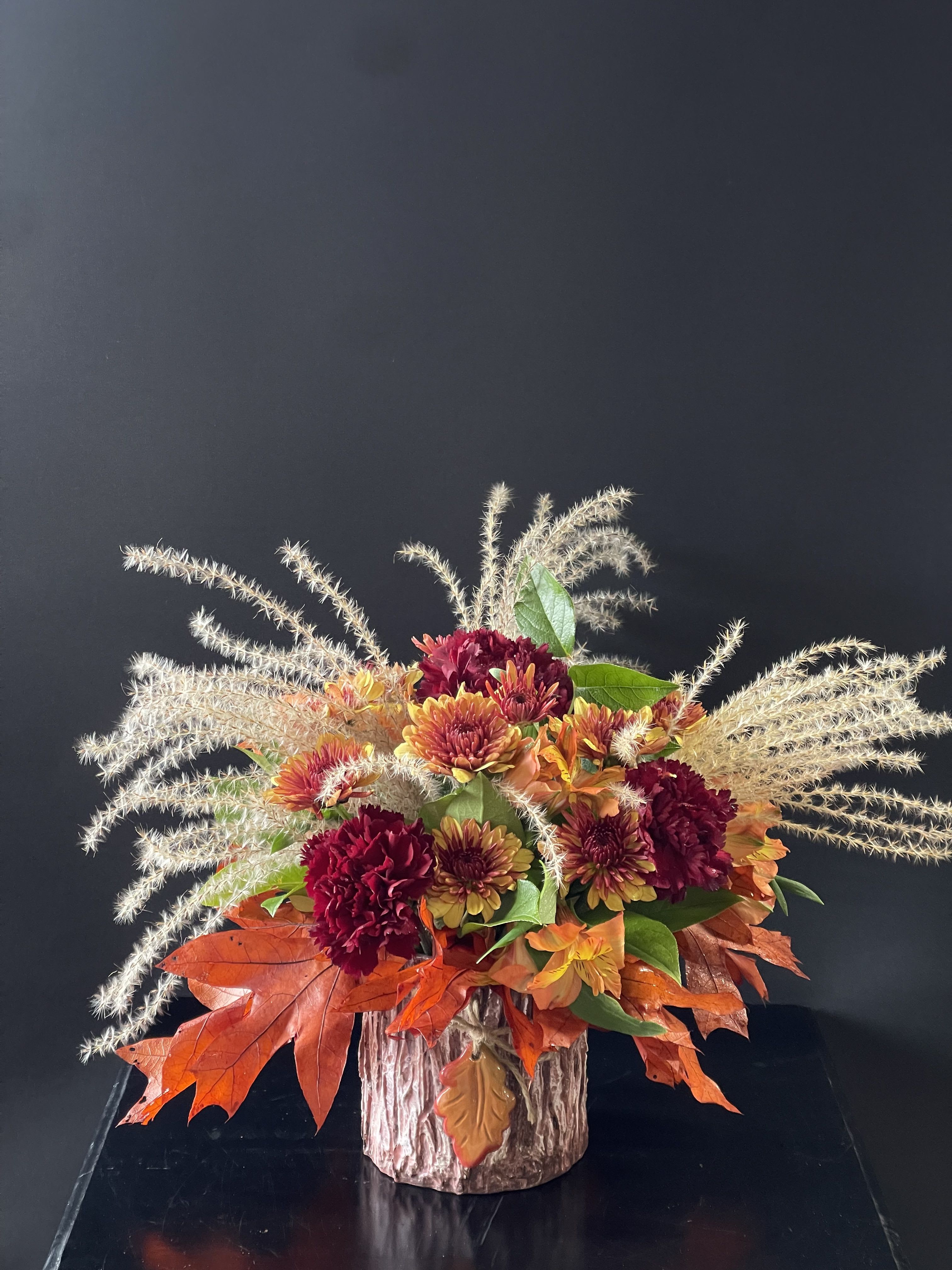 Fall Feels - An arrangement that feels like a cozy fall day with fall leaves, carnations, cushions, alstroemeria, and pampas grass
