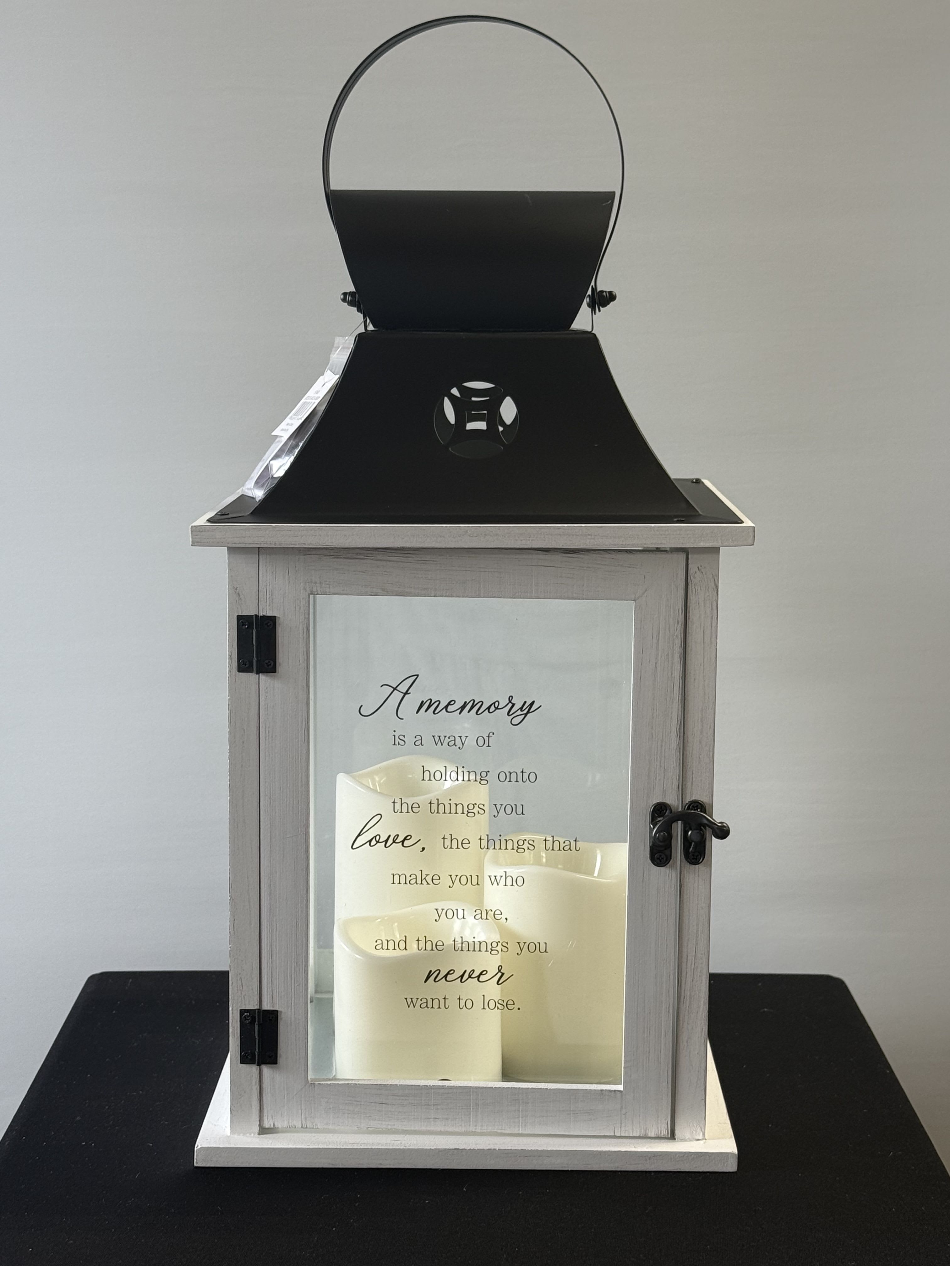 A Memory Lantern - 3 Pilar LED Candle Lantern With Saying. "A memory is a way of holding onto the things you love, the things that make you who you are, and the things you never want to loose."
