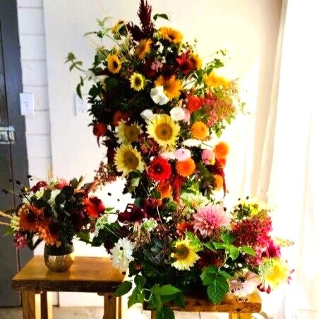 Large colorful floral arrangement with sunflowers and mixed blooms