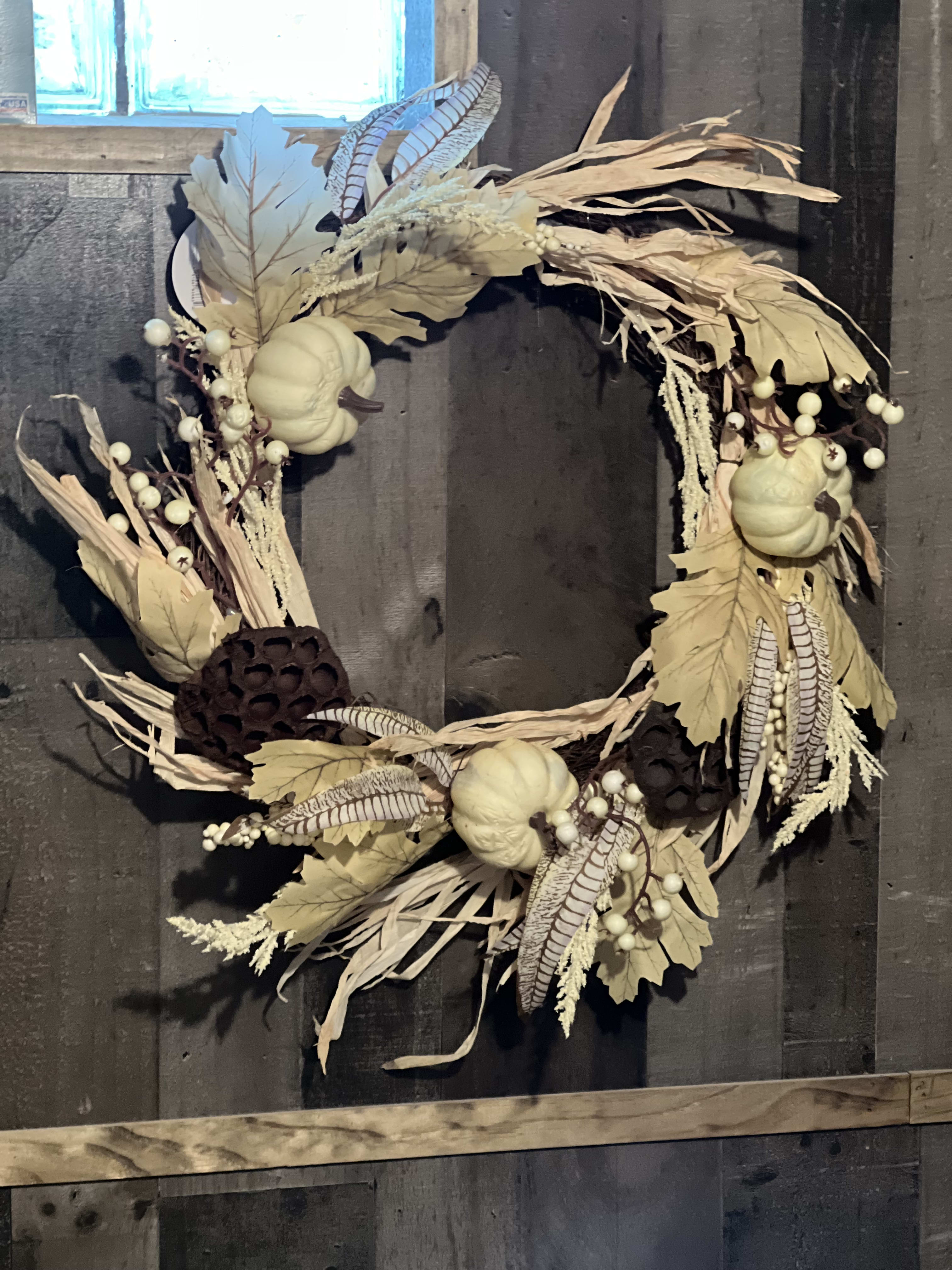 Beautiful Autumn Wreath - A Beautiful Autumn Wreath. Ready to hang on your door or patio. Festive white silk feathers with white autumn pumpkins and brown lotus pos. Perfect to greet your guest as they enter. 22" round decorated wreath. ( only 1 left.)