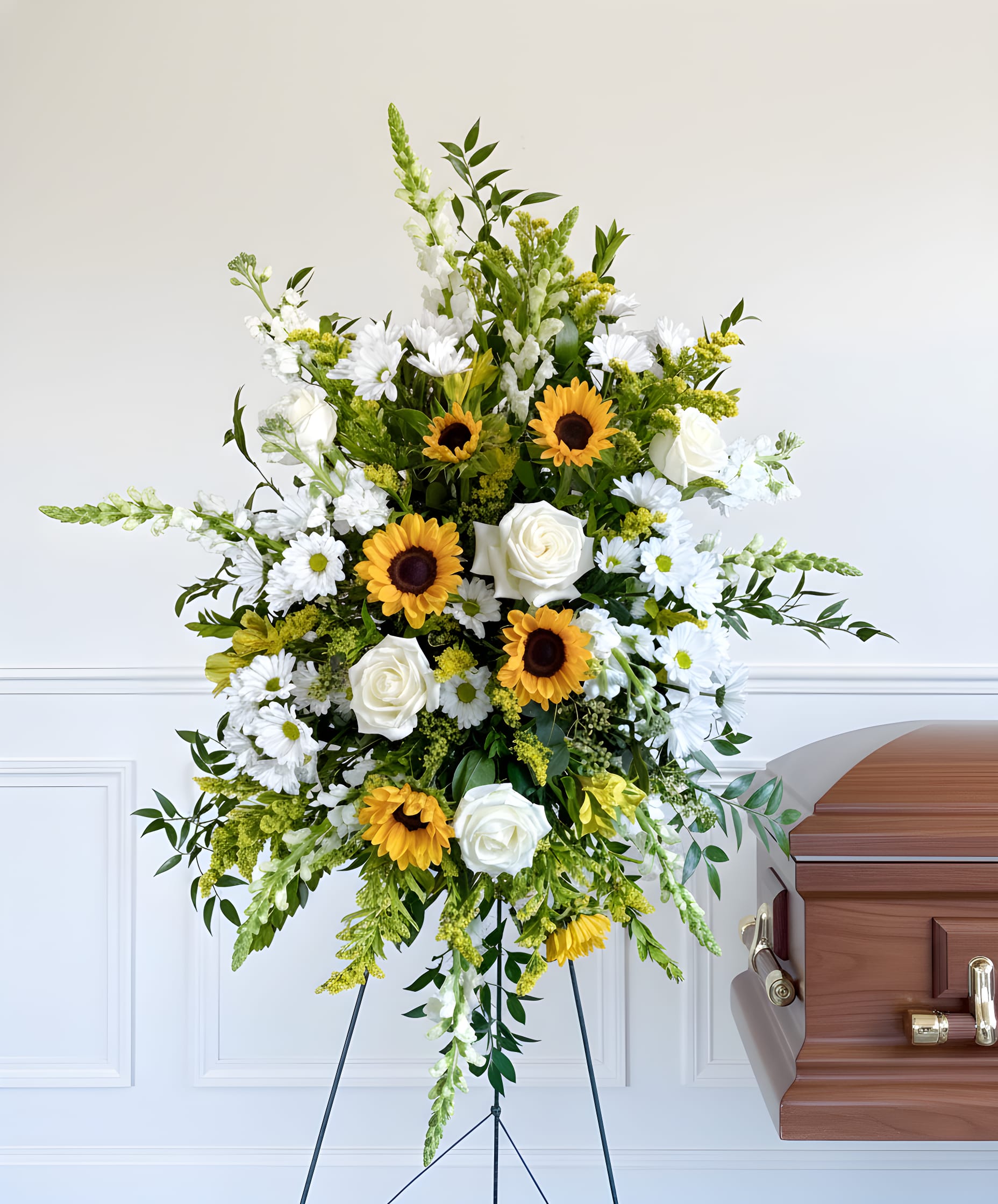 White Standing Spray with Sunflowers  - An all white standing spray with pops of sunflowers and solidego. Includes snapdragons, roses, daisies and alstroemeria and measures 3ft tall by 2 feet wide. 