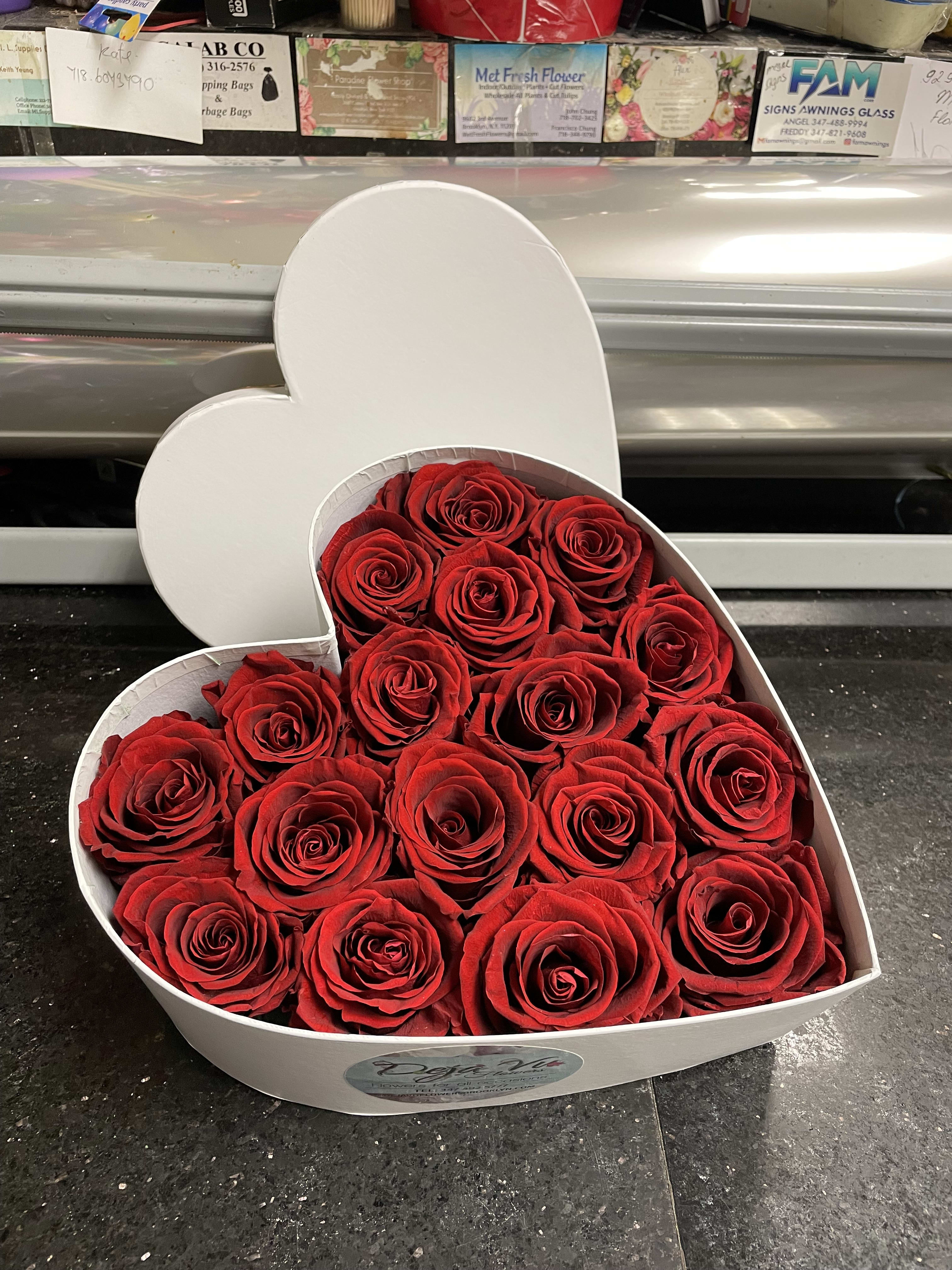 Heart-shaped box filled with red roses
