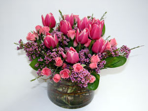 Pink tulips and spray roses in a glass vase