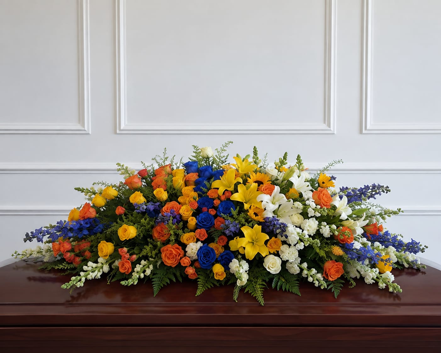 Large multicolored floral casket spray with roses and lilies