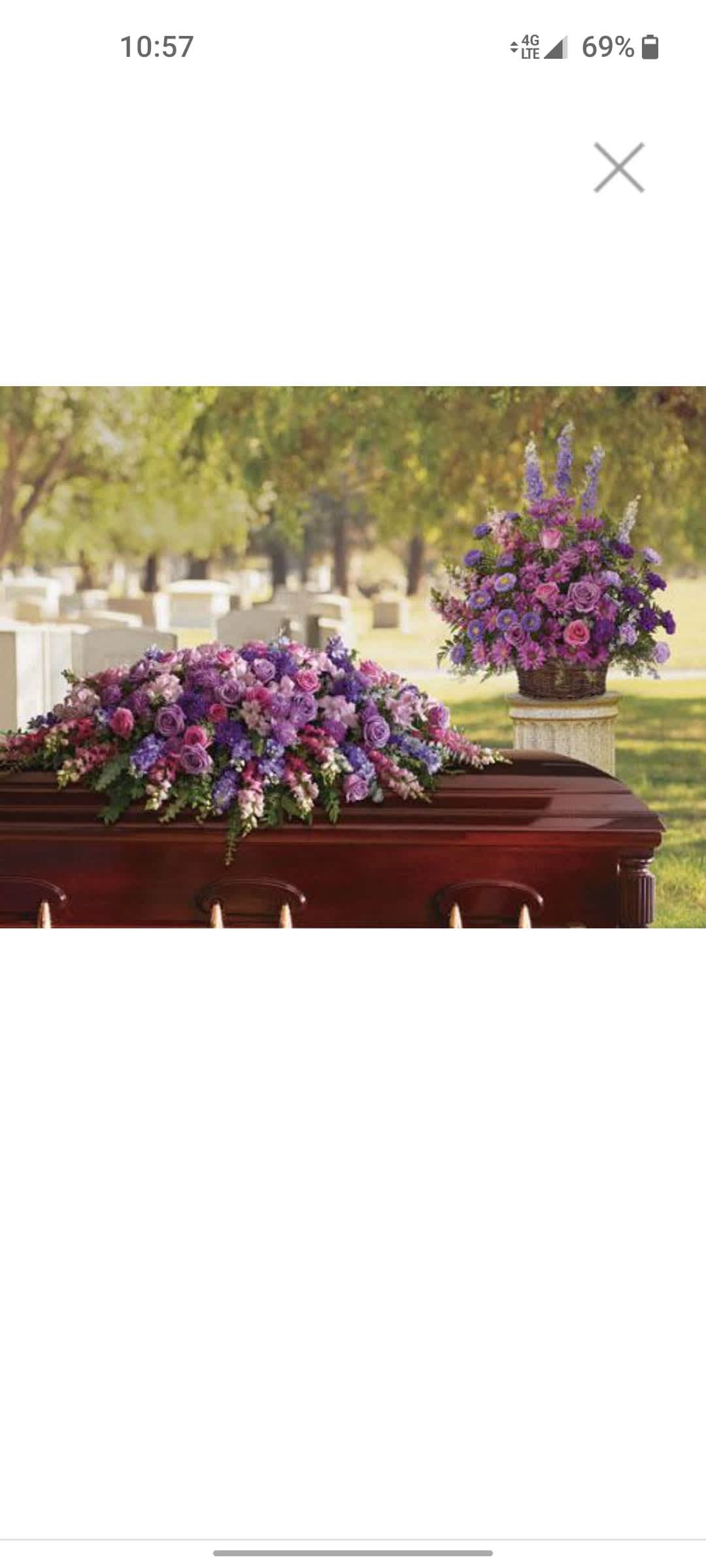 Purple and pink floral casket spray with a matching basket arrangement