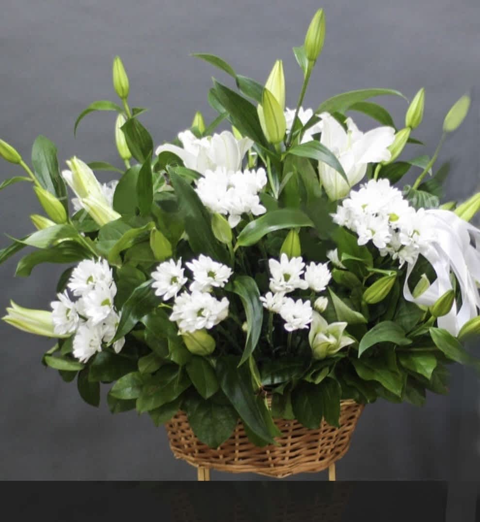 Lily- Chrysanthemum Delight - The "Lily-Chrysanthemum Delight" is a stunning arrangement of elegant lilies and cheerful chrysanthemums presented in a charming basket. This beautiful combination brings together the grace of lilies and the vibrant charm of chrysanthemums, creating a delightful display perfect for any occasion.