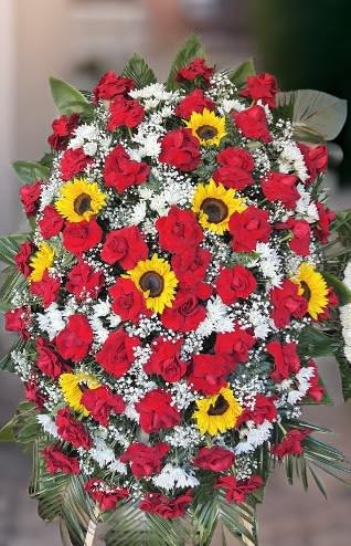 Elegant Funeral Spray - This stunning funeral spray is a heartfelt expression of sympathy, respect, and eternal love. Featuring a striking combination of red roses, bright sunflowers, delicate white blooms, and lush greenery, this floral arrangement serves as a beautiful tribute to honor and remember a loved one.   Premium red roses symbolizing love and devotion  Bright sunflowers representing warmth, strength, and remembrance  Lush greenery and white accents for a balanced and elegant look ️ Perfect for funerals, memorial services, and tribute ceremonies