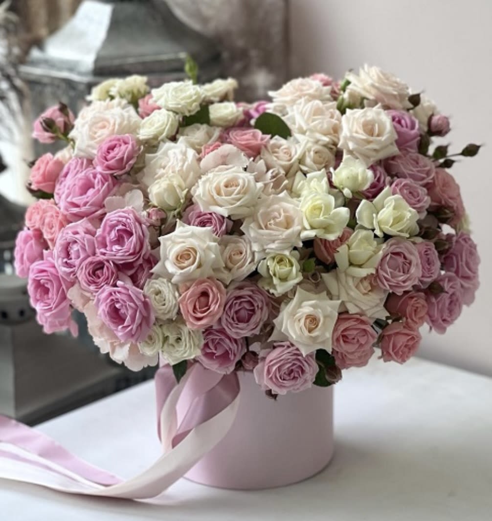 Pink and white rose bouquet in a round pink box with ribbon