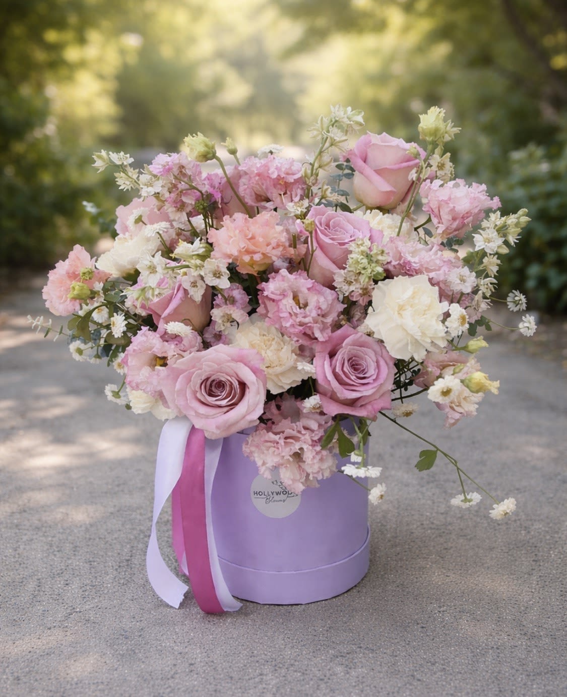 Pink and white rose bouquet in a lavender hat box with ribbon