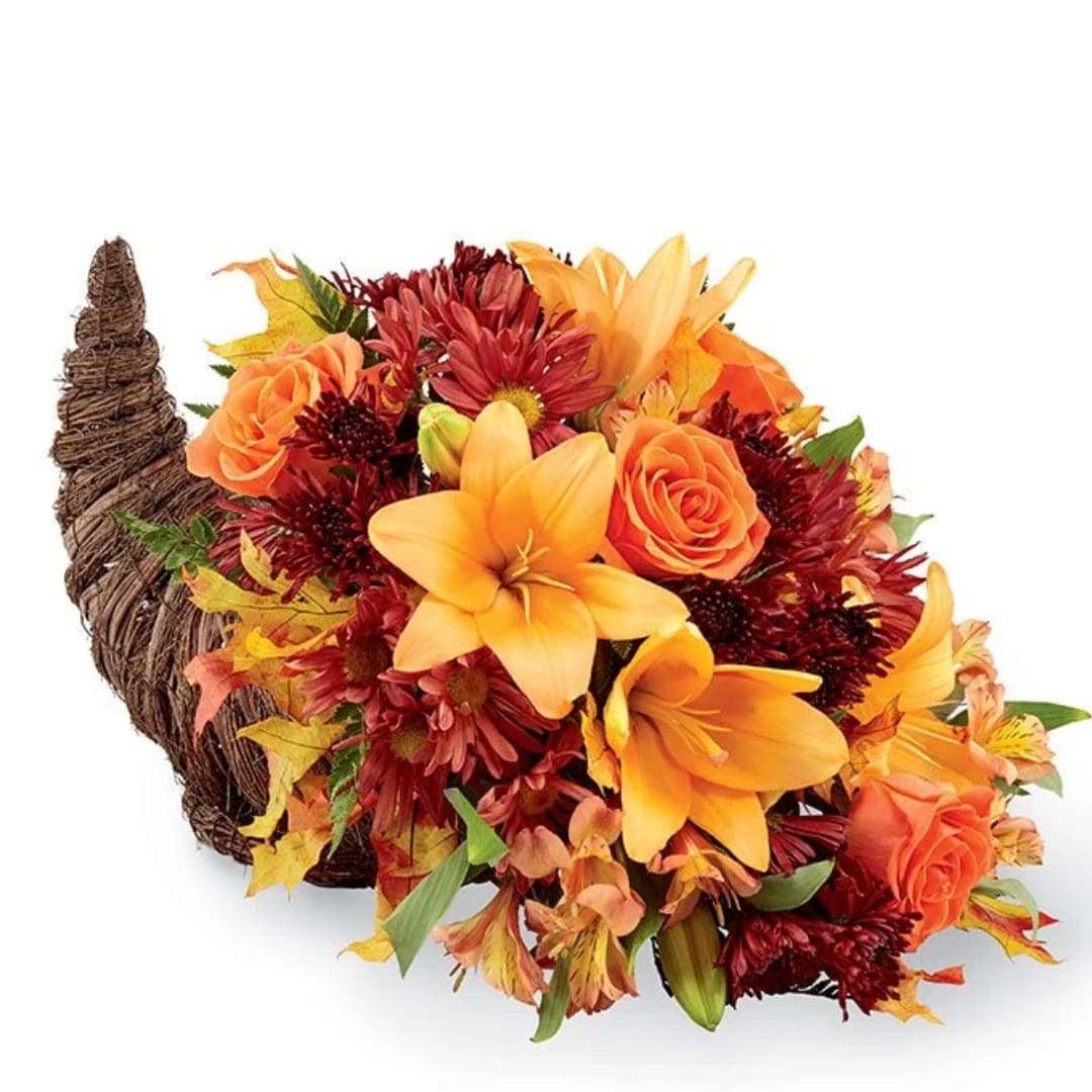 Autumn floral arrangement in a woven cornucopia basket with orange and red blooms