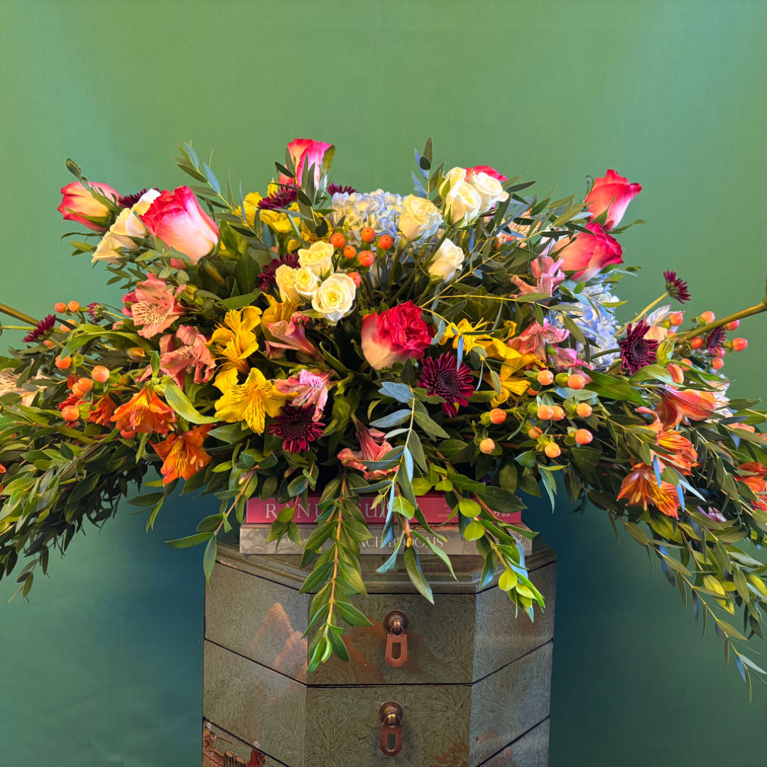 Large mixed bouquet with pink roses, yellow blooms, and orange berries