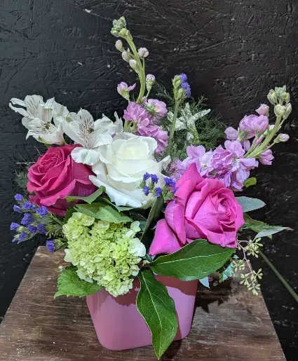 Hugs n' Kisses - BRIGHT PINK AND WHITE ROSES WITH LAVENDER ACCENTS, GREEN HYDRANGEA AND AIRY ALSTROEMERIA IN A COMPACT PINK CUBE-CHEERFUL BOUQUET FOR BIRTHDAYS OR THANK-YOU MOMENTS.