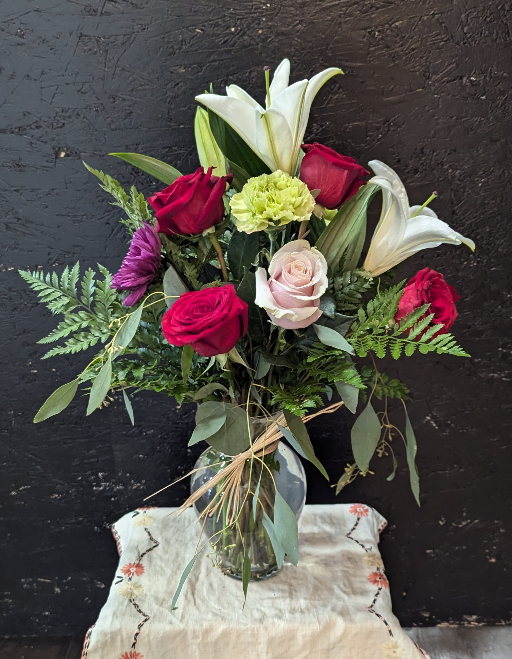 Lilies n' Roses - ORIENTAL LILIES, COLORFUL ASSORTMENT OF ROSES, MUMS CARNATIONS, EUCALYPTUS AND GREENS.