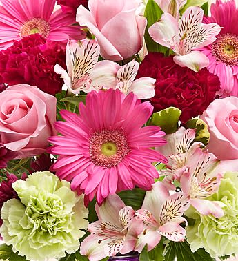 Pink gerbera daisies, roses, carnations, and alstroemeria in a mixed bouquet