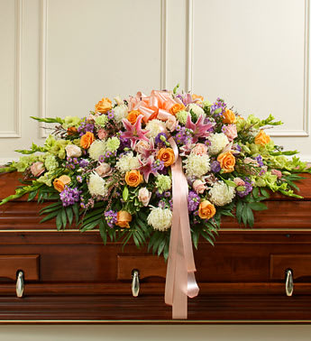 Large floral casket spray with pink, orange, and white blooms