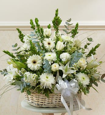 White floral basket arrangement with a ribbon bow